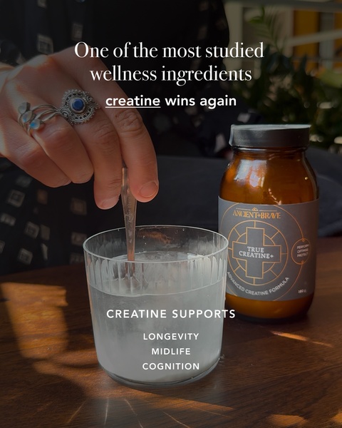 A close-up, high-quality product shot showing a woman stirring a powdered supplement drink, highlighting its benefits for longevity and cognition.